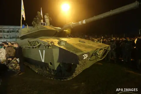 Palestinian members of the Ezzedine al-Qassam Brigades, the armed wing of the Hamas movement, gather around a mock Israeli tank on January 31, 2016 in Gaza city during a gathering to pay tribute to the brigade's militant...