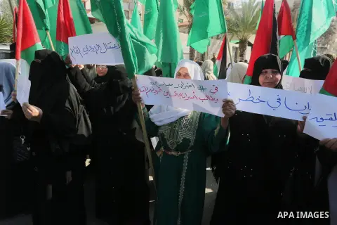 Palestinian women hold banners during a protest to show solidarity with journalist Mohammed al-Qiq who is imprisoned in an Israeli jail, Gaza city, on February 02, 2016. Photo by Mohammed Asad