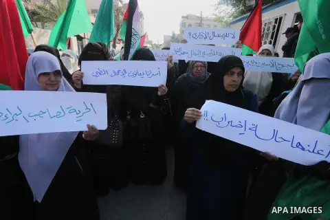 Palestinian women hold banners during a protest to show solidarity with journalist Mohammed al-Qiq who is imprisoned in an Israeli jail, Gaza city, on February 02, 2016. Photo by Mohammed Asad