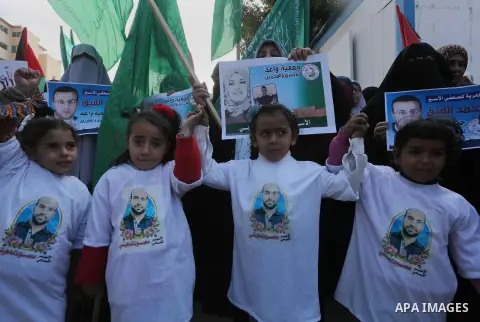 Palestinian women hold banners during a protest to show solidarity with journalist Mohammed al-Qiq who is imprisoned in an Israeli jail, Gaza city, on February 02, 2016. Photo by Mohammed Asad