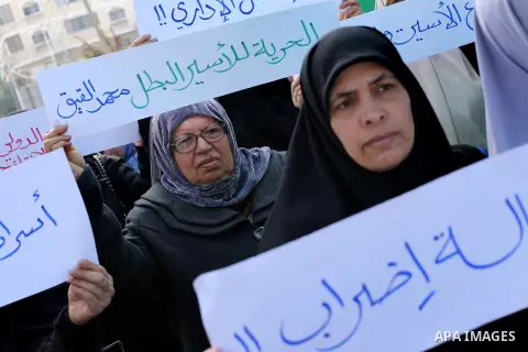 Palestinian women hold banners during a protest to show solidarity with journalist Mohammed al-Qiq who is imprisoned in an Israeli jail, Gaza city, on February 02, 2016. Photo by Mohammed Asad
