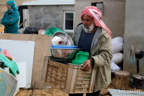 A Palestinian man collects items from his home after it was demolished by Israeli bulldozers in a disputed military zone in the area of Musafir Jenbah, which includes several villages, south of the West Bank town of Hebr...