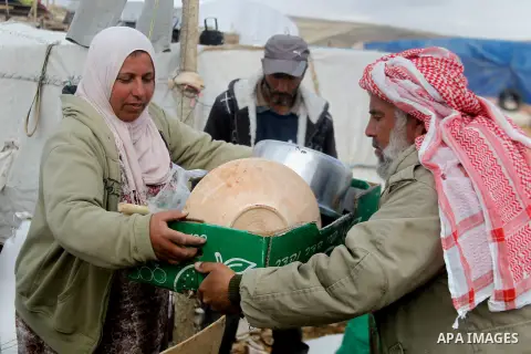 Palestinians collect items from their home after it was demolished by Israeli bulldozers in a disputed military zone in the area of Musafir Jenbah, which includes several villages, south of the West Bank town of Hebron o...