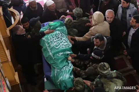 Palestinian militants carry the body of their comrade Fuad Abu Atewi, who was killed when a tunnel collapse on Tuesday, during his funeral in the village of Al-Moghraga near the Nuseirat refugee camp in the central Gaza...