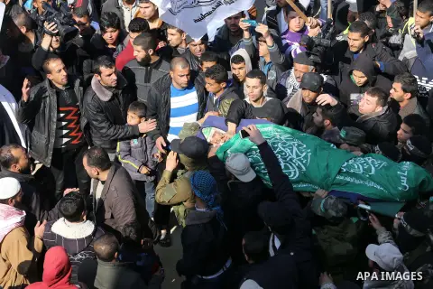 Palestinian militants carry the body of their comrade Fuad Abu Atewi, who was killed when a tunnel collapse on Tuesday, during his funeral in the village of Al-Moghraga near the Nuseirat refugee camp in the central Gaza...