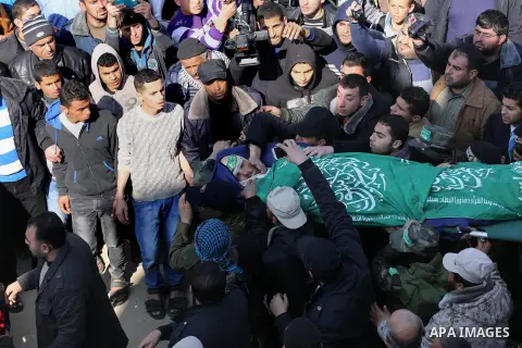 Palestinian militants carry the body of their comrade Fuad Abu Atewi, who was killed when a tunnel collapse on Tuesday, during his funeral in the village of Al-Moghraga near the Nuseirat refugee camp in the central Gaza...