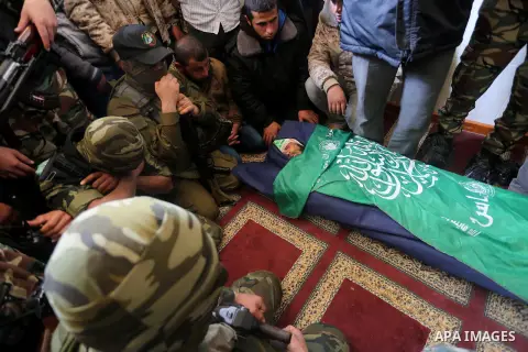 Palestinian militants mourn around the body of Fuad Abu Atewi, who was killed when a tunnel collapse on Tuesday, mourn during his funeral in the village of Al-Moghraga near central Gaza Strip, February 3, 2016. The colla...