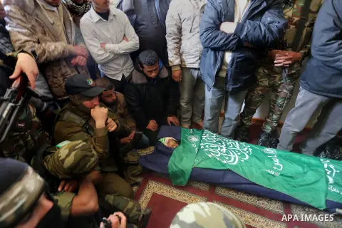 Palestinian militants mourn around the body of Fuad Abu Atewi, who was killed when a tunnel collapse on Tuesday, mourn during his funeral in the village of Al-Moghraga near central Gaza Strip, February 3, 2016. The colla...