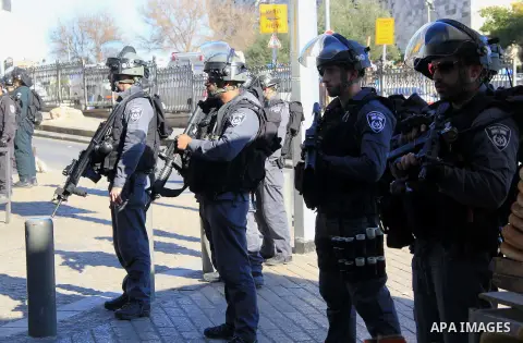 Israeli border policemen stand guard following an attack by three Palestinian assailants at Damascus Gate, a main entrance to Jerusalem's Old City on February 3, 2016. Three Palestinians armed with a gun, knives and expl...