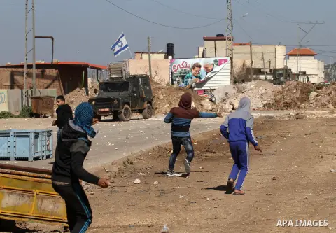 Palestinian protesters hurl stones toward Israeli security forces during clashes in Qabatiya, a town near Jenin in the north of the Israeli-occupied West Bank, on February 4, 2016. Israeli forces locked down Qabatiya tha...