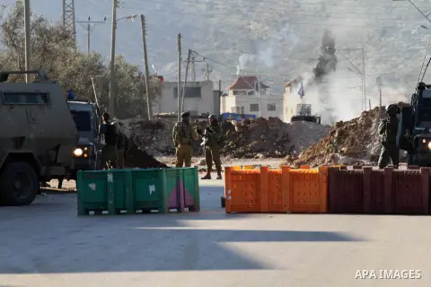 Israeli security forces take a position during clashes with Palestinian protesters in Qabatiya, a town near Jenin in the north of the Israeli-occupied West Bank, on February 4, 2016. Israeli forces locked down Qabatiya t...