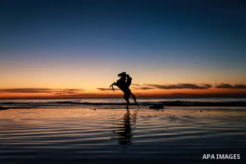 A Palestinian man rides horse during the sunset on the beach of Gaza city on Feb. 04, 2016. Photo by Mohammed Dahman