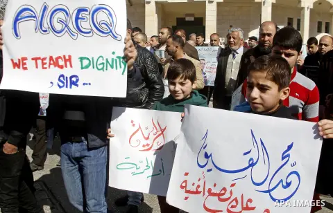 Palestinian demonstrators hold posters bearing portraits of Palestinian journalist Mohammed al-Qiq who is imprisoned in an Israeli jail during a protest in support of his hunger strike in the West Bank city of Hebron on...