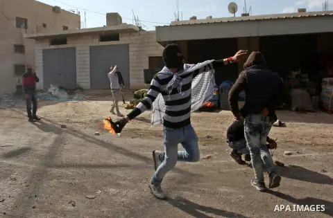 A Palestinian protester hurls a molotov cocktail towards Israeli security forces during clashes in the Palestinian town of Qabatiya, near Jenin in the north of the Israeli-occupied West Bank, on February 5, 2016. The Isr...