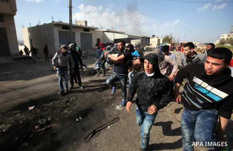 A wounded Palestinian protester is evacuated during clashes with Israeli security forces in the Palestinian town of Qabatiya, near Jenin in the north of the Israeli-occupied West Bank, on February 5, 2016. The Israeli ar...