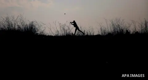 Palestinian protesters clash with Israeli security forces following a demonstration in solidarity with Palestinian prisoners in Israeli jails, outside the compound of the Israeli Ofer Military Prison, near the West Bank...