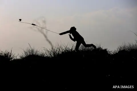 Palestinian protesters clash with Israeli security forces following a demonstration in solidarity with Palestinian prisoners in Israeli jails, outside the compound of the Israeli Ofer Military Prison, near the West Bank...