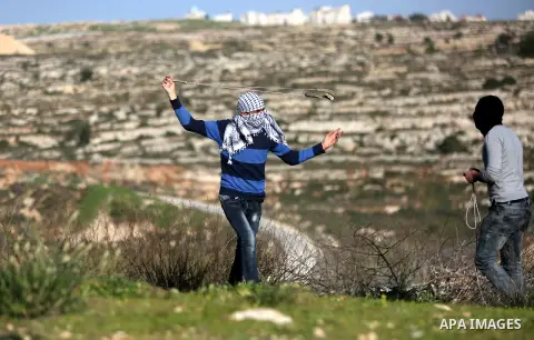 Palestinian protesters clash with Israeli security forces following a demonstration in solidarity with Palestinian prisoners in Israeli jails, outside the compound of the Israeli Ofer Military Prison, near the West Bank...