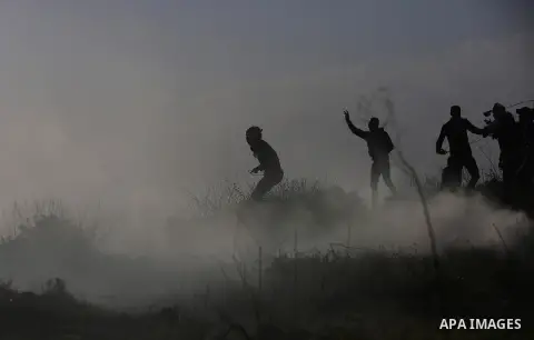 Palestinian protesters clash with Israeli security forces following a demonstration in solidarity with Palestinian prisoners in Israeli jails, outside the compound of the Israeli Ofer Military Prison, near the West Bank...