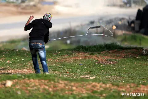 Palestinian protesters clash with Israeli security forces following a demonstration in solidarity with Palestinian prisoners in Israeli jails, outside the compound of the Israeli Ofer Military Prison, near the West Bank...