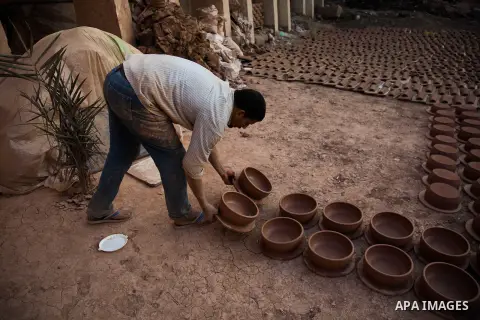 An Egyptian man works at a pottery workshop in Cairo, on February 6, 2016. Pottery is an ancient and traditional craft in Gaza. Local workshops usually produce products such as bowls, pitchers, flower pots, and vases. Ph...