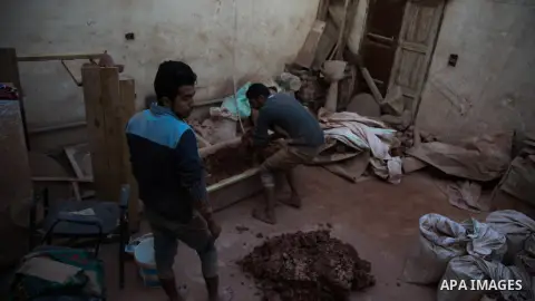 An Egyptian man, uses a pottery wheel to construct a clay vessel, at a pottery workshop in Cairo, on February 6, 2016. Pottery is an ancient and traditional craft in Gaza. Local workshops usually produce products such as...
