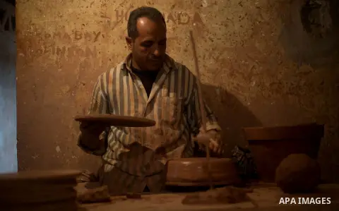 An Egyptian man, uses a pottery wheel to construct a clay vessel, at a pottery workshop in Cairo, on February 6, 2016. Pottery is an ancient and traditional craft in Gaza. Local workshops usually produce products such as...