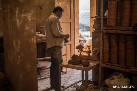 An Egyptian man works at a pottery workshop in Cairo, on February 6, 2016. Pottery is an ancient and traditional craft in Gaza. Local workshops usually produce products such as bowls, pitchers, flower pots, and vases. Ph...