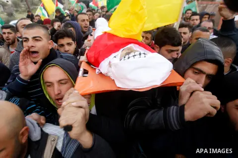 Mourners carry the body of Palestinian Haitham Al-Bau, who was shot and killed by Israeli soldiers, during his funeral, in the West Bank city of Hebron February 6, 2016. Israeli soldiers shot and killed Al-Bao, 17, in th...