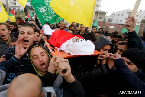 Mourners carry the body of Palestinian Haitham Al-Bau, who was shot and killed by Israeli soldiers, during his funeral, in the West Bank city of Hebron February 6, 2016. Israeli soldiers shot and killed Al-Bao, 17, in th...