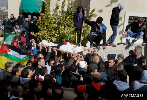 Mourners carry the body of Palestinian Haitham Al-Bau, who was shot and killed by Israeli soldiers, during his funeral, in the West Bank city of Hebron February 6, 2016. Israeli soldiers shot and killed Al-Bao, 17, in th...