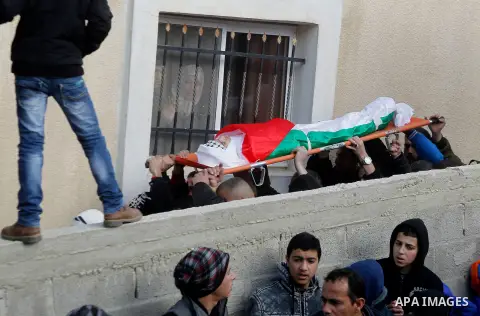 Mourners carry the body of Palestinian Haitham Al-Bau, who was shot and killed by Israeli soldiers, during his funeral, in the West Bank city of Hebron February 6, 2016. Israeli soldiers shot and killed Al-Bao, 17, in th...