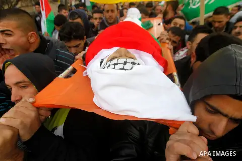 Mourners carry the body of Palestinian Haitham Al-Bau, who was shot and killed by Israeli soldiers, during his funeral, in the West Bank city of Hebron February 6, 2016. Israeli soldiers shot and killed Al-Bao, 17, in th...