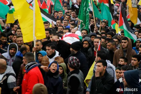 Mourners carry the body of Palestinian Haitham Al-Bau, who was shot and killed by Israeli soldiers, during his funeral, in the West Bank city of Hebron February 6, 2016. Israeli soldiers shot and killed Al-Bao, 17, in th...
