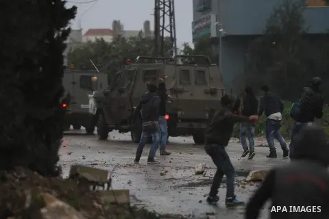 A Palestinian protester prepares his sling to hurl stones towards Israeli troops during clashes in the West Bank town of Qabatya, near Jenin February 6, 2016. On Wednesday, three young Palestinian men from Qabatya wieldi...