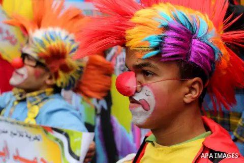 Palestinians dressed as clowns take part in a protest demanding release the prisoners in Israeli jails, in front of Red cross office, in Gaza city, on February 8, 2016. Photo by Mohammed Asad