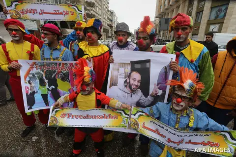 Palestinians dressed as clowns take part in a protest demanding release the prisoners in Israeli jails, in front of Red cross office, in Gaza city, on February 8, 2016. Photo by Mohammed Asad