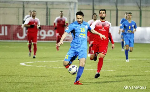 Ahly Al-Khalil football club's players (in red) and FC Khujand club's players compete during the football match crucial AFC Champions League Playoff phase at Dura Stadium in the West Bank city of Hebron on Feb. 09, 2016....