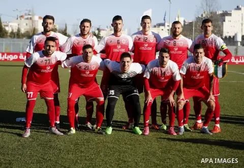 Ahly Al-Khalil football club's players pose for a group picture before their match with FC Khujand during the football match crucial AFC Champions League Playoff phase at Dura Stadium in the West Bank city of Hebron on F...