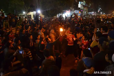 Fans of Al Ahly football club celebrate after their Egyptian Premier League derby soccer match against El Zamalek at Borg El Arab "Army Stadium" near Alexandria, Egypt, February 9, 2016. Photo by Amr Sayed