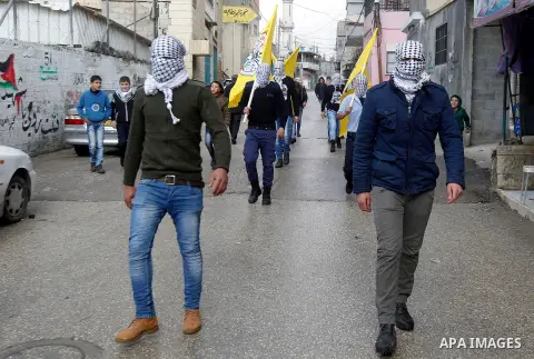 Masked Palestinians take part in the funeral of Omar Jawabra, who was killed by Israeli fire during clashes near hebron the day before, at al-Aroub Palestinian refugee camp, north the West Bank city of Hebron on February...