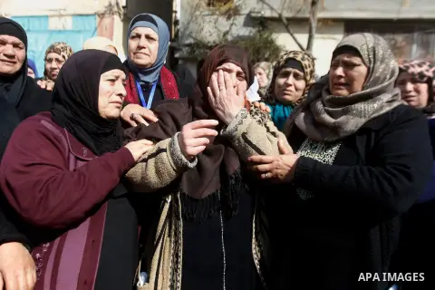 The mother (C) of Palestinian youth Omar Jawabra, who was killed by Israeli fire during clashes near hebron the day before, mourns during his funeral at al-Aroub Palestinian refugee camp, north the West Bank city of Hebr...