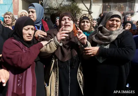 The mother (C) of Palestinian youth Omar Jawabra, who was killed by Israeli fire during clashes near hebron the day before, mourns during his funeral at al-Aroub Palestinian refugee camp, north the West Bank city of Hebr...