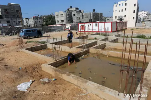 Palestinian children stand near the building columns for their families houses , destroyed during 2014 war, in Shijaiyah neighborhood in the east of Gaza city on Feb. 11, 2016. Rebuilding of Palestinian houses which dest...