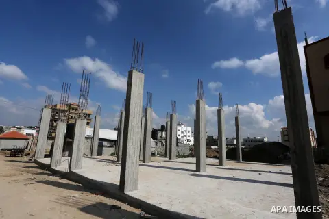 Palestinian children stand near the building columns for their families houses , destroyed during 2014 war, in Shijaiyah neighborhood in the east of Gaza city on Feb. 11, 2016. Rebuilding of Palestinian houses which dest...