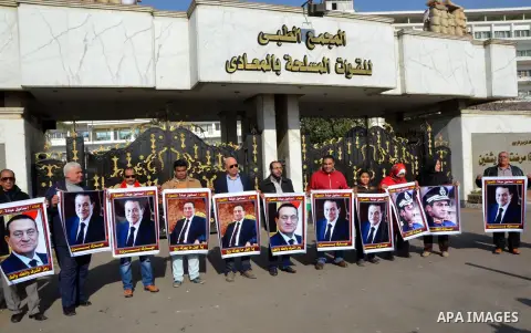 Supporters of Egypt's former president Hosni Mubarak take part during a protest to show solidarity with him outside the Maadi military hospital in Cairo on Feb. 11, 2016. Photo by Amr Sayed