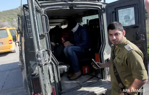 Israeli security forces detain Palestinian protesters during clashes following a protest against the expropriation of Palestinian land by Israel in the West Bank village of Kafr Qaddum, near the northern city of Nablus o...