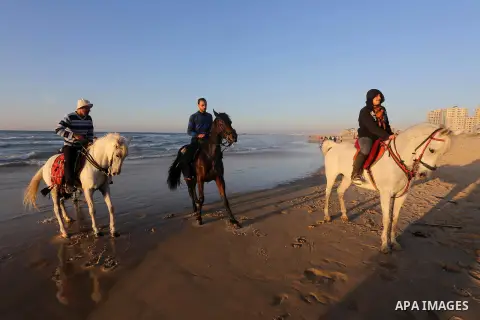 Palestinian youths show their skills on ride horses on the beach of Gaza city on Feb. 12, 2016. Photo by Mohammed Asad