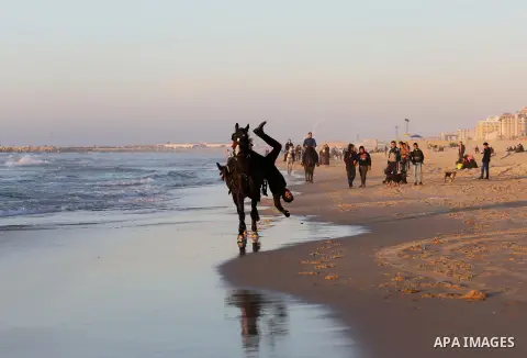 A Palestinian youth shows his skills on rides horses on the beach of Gaza city on Feb. 12, 2016. Photo by Mohammed Asad