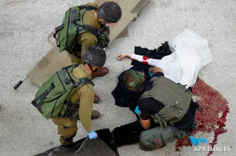 Israeli security forces carry the body of a Palestinian woman tried to stab an Israeli soldier before being shot dead, in the Israeli occupied West Bank city of Hebron, on February 13, 2016. An Israeli army statement sai...